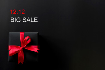 Online shopping of China.,Top view of black christmas gift boxes with red ribbon and text on black background with copy space for text., 12.12 single day sale concept and advertisement.