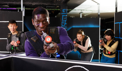Fototapeta na wymiar African American man playing lasertag