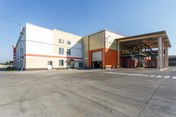 Fototapeta premium manufacture building of modern waste recycling processing plant in orange style. Separate garbage collection. Recycling and storage of waste for further disposal.