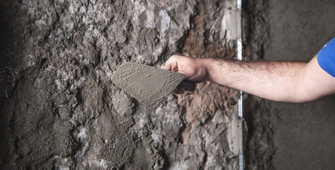 Caucasian worker plastering wall. Construction work