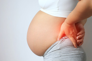 Pregnant women with low back pain on white background,Health concept