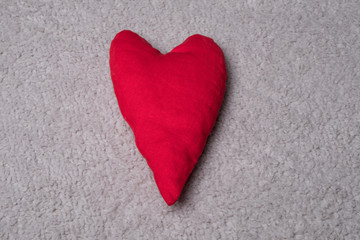 Fabric heart studio image. Red heart on a gray background.
