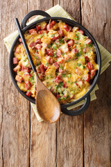 Traditional american strata with ham, bread, onions, cheese and eggs close-up. Vertical top view
