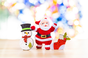 Christmas concept background, Santa with snowman and red sock over blurred colorful bokeh background, decoration item for Christmas, festive season background