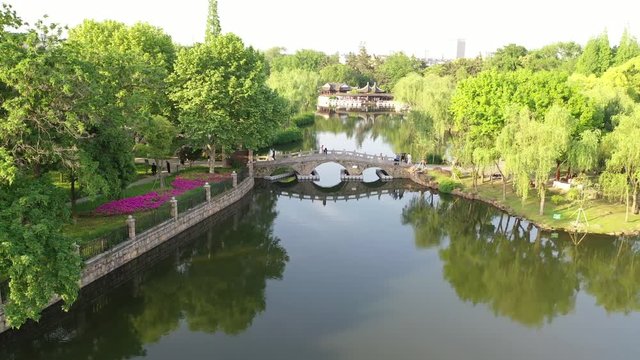 Drone fly by view of lake garden park in Suzhou