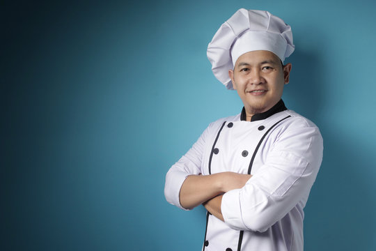 Happy Proud Asian Chef Smiling At Camera With Crossed Arms