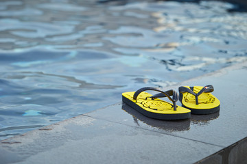 Flip flops at swimming pool 
