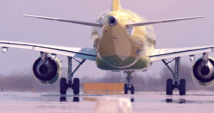 The yellow aircraft move to the runway, a stream of hot air escapes from the turbines