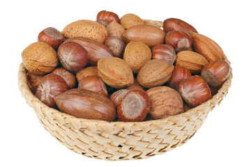 Wicker basket with hazelnuts walnuts almonds and cashew nuts for Christmas table isolated macro