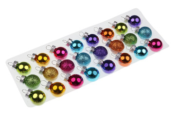 Small new glass Christmas balls for decorating a Xmas fir tree  in plastic packaging isolated macro