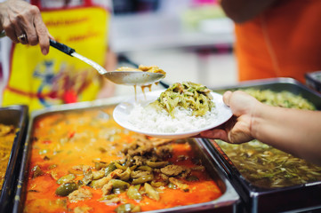 Food Sharing Society: Volunteers are sharing food to hungry people in society.