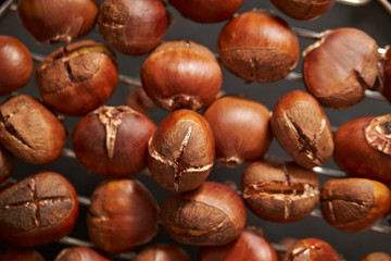 Roasted chestnuts on metal grill 