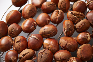 Roasted chestnuts on metal grill 