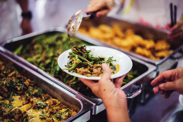 Warm food scooped from ladle into a container of the poor: the concept of giving