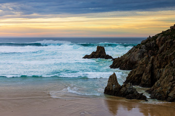 Fototapeta na wymiar Campelo Beach at Dusk under Dramatic Yellow and Blue Sky Ferrol La Coruna Galicia