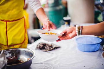 The concept of hunger: Volunteers draw food to donate to hungry people with concern.