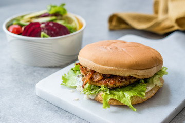 Fast Food Menu Salmon Burger with Take Away Salad in Plastic Box.