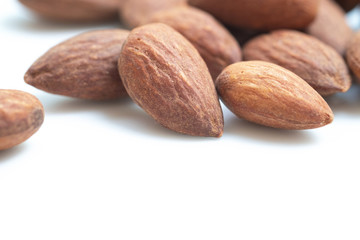 Flavored almonds on white background.