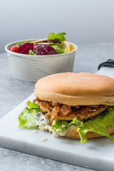 Fast Food Menu Salmon Burger with Take Away Salad in Plastic Box.