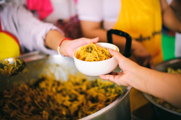 The beggars receive food from the help of the generous in society: the concept of hope and need for...
