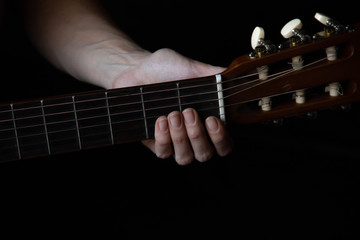 female hands hold an acoustic guitar. play music.