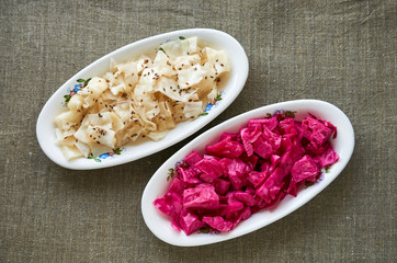 Different marinated cabbage on a white plates