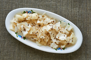 Slices of marinated cabbage on a white plate