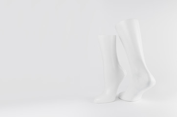 Abstract sculpture of dancing white feet on white background with copy space, simple modern style.