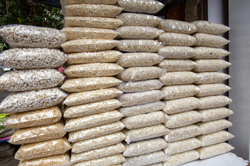 Piles of dry rice puffs and nuts, on sale in a shop in the street in Mumbai, India.