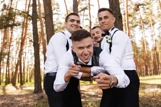 Groom and groomsmen having fun at wedding day