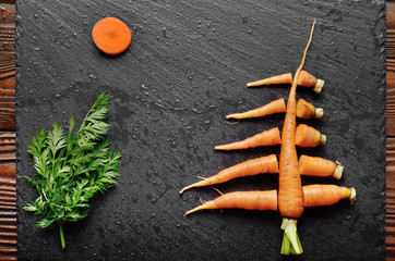Top view at stylised christmas tree made of carrots on slate stone tray