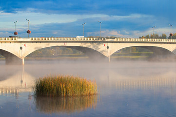 foggy beautiful morning in autumn near view of the bridge for transport