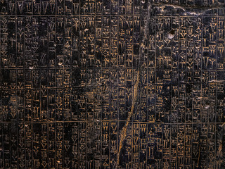 Ancient sumerian stone carving with cuneiform scripting