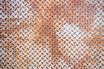 A rusty metal diamond plate texture.