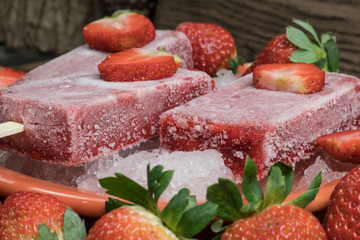 close up of strawberry flavored ice lollipop