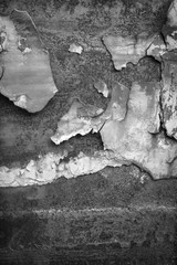 black and white Detail of an old metal wall, rust and cracked paint
