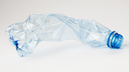 Crumpled plastic bottle on a light background. The concept of ecology