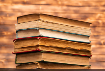 stack of old books on wooden background