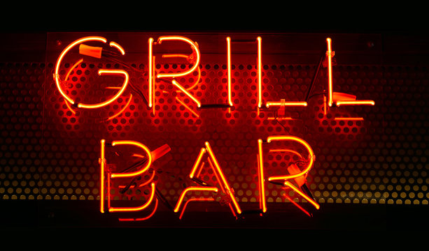 Neon Inscription GRILL BAR In Red On A Dark Wall. Neon Text On The Wall. Interior Design