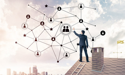 Businessman on house roof presenting networking and connection c