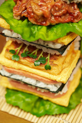 Sushi burger, rice, fried egg and seaweed 