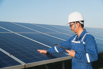operation and maintenance in solar power plant ; engineering team working on checking and...