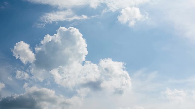 White clouds moving and rolling on blue sky background. 4k time lapse footage.