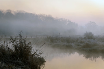 A beautiful sunrise over the misty river.