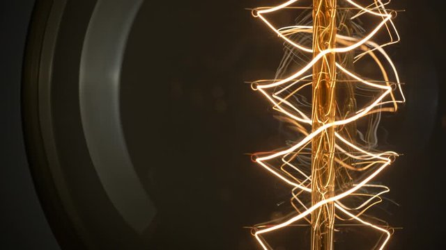 Close up shot of light bulb turning on and off. Macro shot of Edison light bulb lamp incandescent. 4K