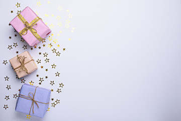 pastel gift boxes with glitter stars on white background