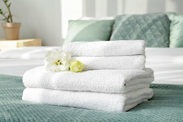Clean soft towels on bed - obrazy, fototapety, plakaty