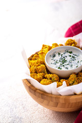cauliflower with sour cream sauce in bowl on white background. dietary garnish concept