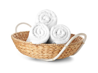 Wicker basket with clean towels isolated on white