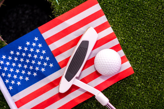 Golf ball and Golf Club on Artificial Grass and USA flag